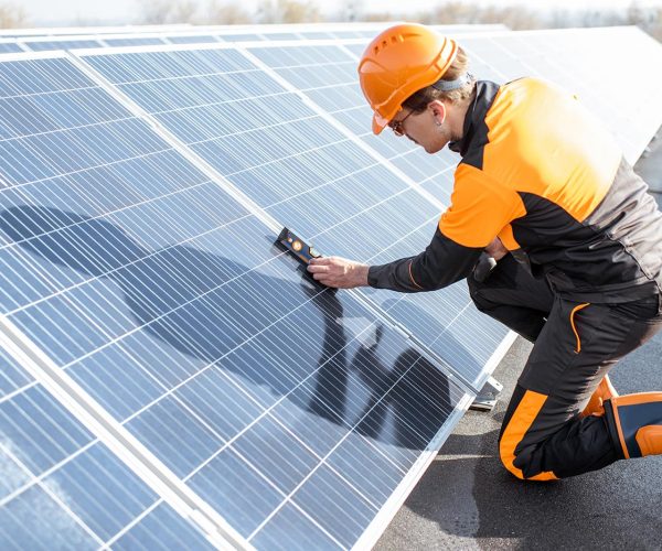 Technician inspecting a rooftop solar array — certified Bengaluru installation team.