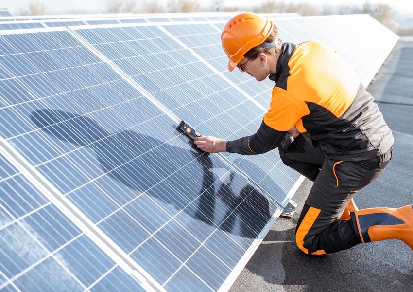 Technician inspecting a rooftop solar array — certified Bengaluru installation team.